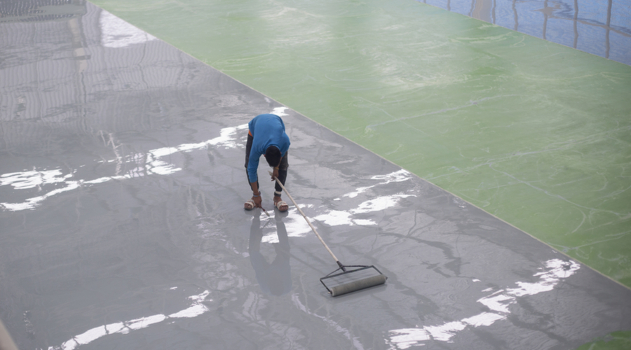 Worker applying epoxy floor