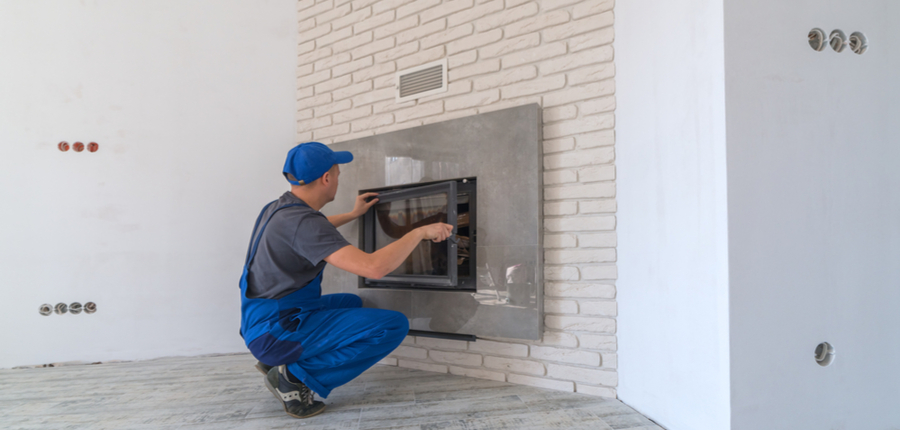 fireplace installing in white brick wall