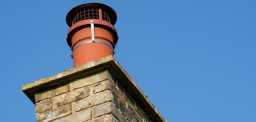 Chimney cap on an old cottage chimney pot