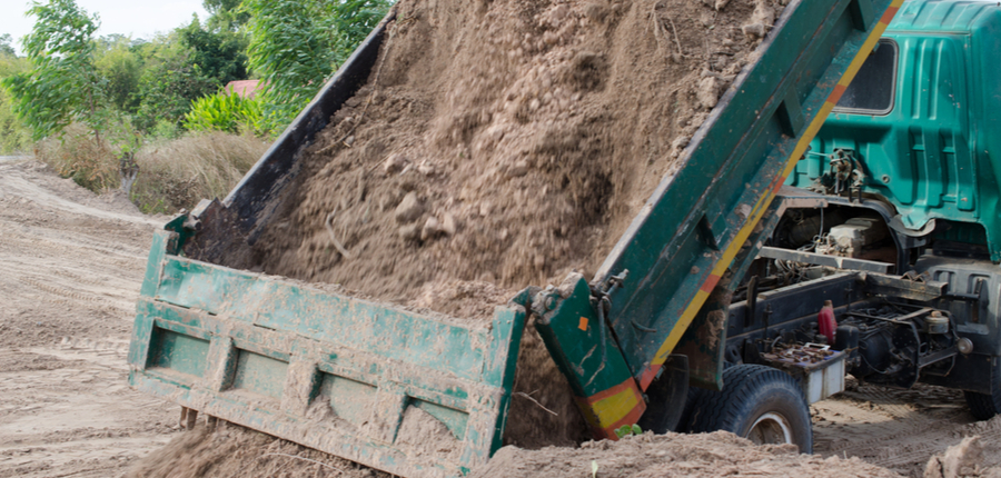 dump trucks carrying fill dirt