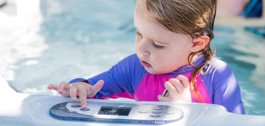 cute girl playing in jacuzzi controls